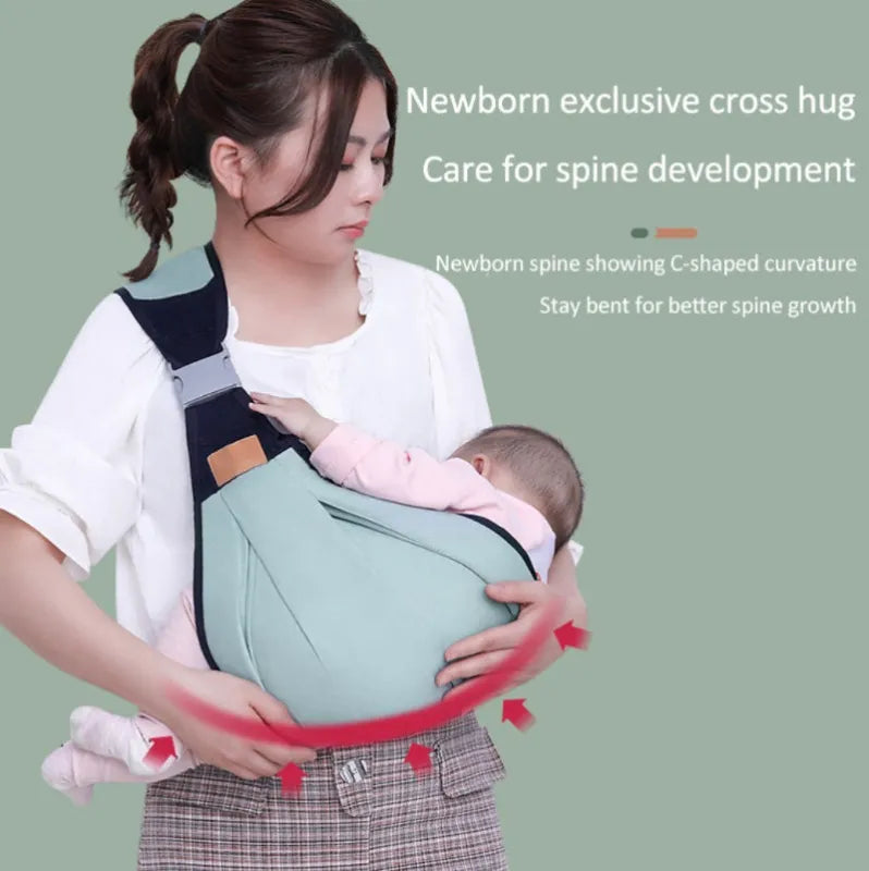 Woman holding a baby in a green baby carrier against a green background