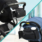 Black stroller organizer with phone and cup holder attached to a stroller