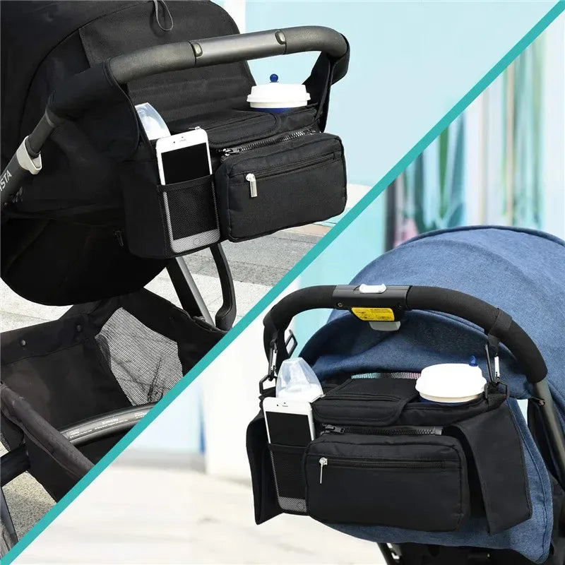 Black stroller organizer with phone and cup holder attached to a stroller