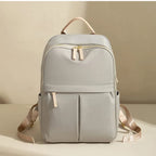 Light gray backpack with beige straps on a beige background