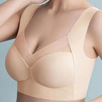 Beige high support sport bra worn by a model on a light gray background