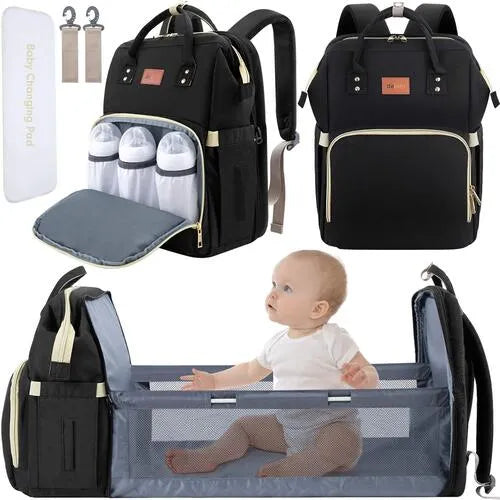 Black diaper bag with baby changing pad and baby sitting inside the bag
