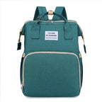 Green multifunction portable diaper backpack with white accents on a white background
