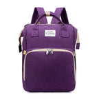 Purple multifunction portable diaper backpack with white accents on a white background