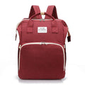 Red multifunction portable diaper backpack with white accents on a white background