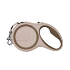Beige and khaki retractable dog leash on a white background
