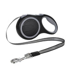 Retractable dog leash with black handle on a white background