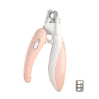 Pink led pet nail clipper and batteries on a white 
