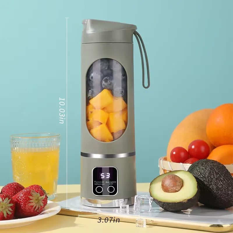 Green portable blender showing dimensions with fruits and a glass of juice on a light blue background