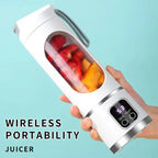 Hand holding a portable juicer with fruits inside against a light blue background
