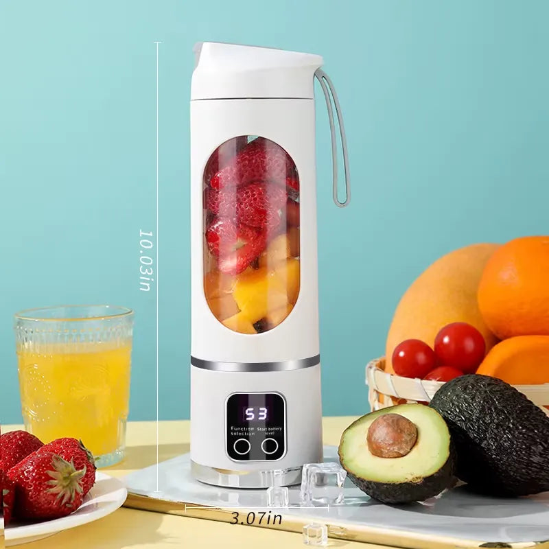 White portable blender showing dimensions with fruits and a glass of juice on a table