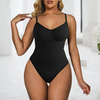 Woman wearing a black bodysuit in a minimal indoor setting