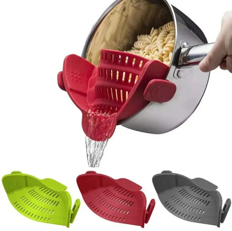 Red silicone strainer being used to drain pasta from a pot, with additional strainers in green and gray displayed below.