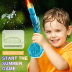 Child holding a blue water gun with water spraying distances, on a green background.